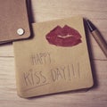 Text happy kiss day in a note