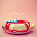 Text Happy Presidents Day and a cake ornamented with the flag of