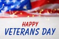 Text HAPPY VETERANS DAY and fairy lights with USA flag Royalty Free Stock Photo