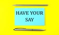 Text HAVE YOUR SAY on the blue sticker on the yellow background Royalty Free Stock Photo