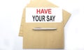 Text HAVE YOUR SAY on paper on envelope on the white background Royalty Free Stock Photo