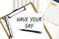 Text HAVE YOUR SAY on the white paper on clipboard with chart and calculator Royalty Free Stock Photo