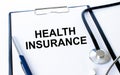 Text Health Insurance on a sheet in the medical folder