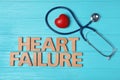 Text Heart Failure with stethoscope on blue wooden background