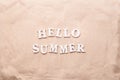 Text Hello Summer from white letters on sand. Royalty Free Stock Photo