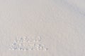 Text HELLO WINTER, written on fresh white snow with shining icy crystals in cold sunny day. Natural winter Christmas and New year Royalty Free Stock Photo