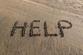 Help written in the sand Royalty Free Stock Photo