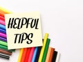 Text HELPFUL TIPS on paper note with colorful pencils Royalty Free Stock Photo