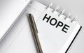 Text HOPE on the short note texture background with pen Royalty Free Stock Photo
