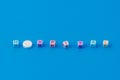 Text HOSPITAL made in cubes, white pill with score instead of the letter O. Classic traditional blue background