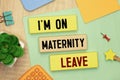 text I'm on Maternity Leave on wooden block Royalty Free Stock Photo