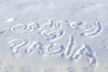Text inscription on snow on a sunny winter day Royalty Free Stock Photo