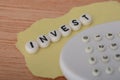 The text INVEST refers to the act of allocating money, resources, or time into an endeavor with the expectation of generating