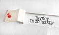 The text Invest in Yourself appearing behind torn yellow paper Royalty Free Stock Photo