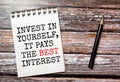 Text Invest in Yourself It pays the best interest written in notepad