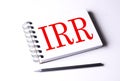 Text IRR on notebook on the white background, business