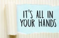 The text ITS ALL IN YOUR HANDS appearing behind torn white paper Royalty Free Stock Photo