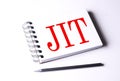 Text JIT on notebook on the white background, business