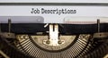 Text `Job Descriptions` typed on retro typewriter. Business concept Royalty Free Stock Photo