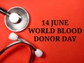 Text 14 june world blood donor day on red background with stethoscope. Royalty Free Stock Photo