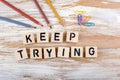 Text: Keep Trying from wooden letterson on wooden background Royalty Free Stock Photo