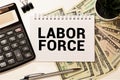 the text labor Force on white noteboock
