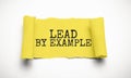 The text lead by example appearing behind torn grey paper Royalty Free Stock Photo