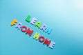 Text LEARN FROM HOME of wooden letters on background with copy space Royalty Free Stock Photo