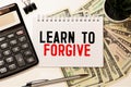 Text Learn to Forgive written with golden letters on a red heart