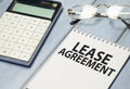 Text LEASE AGREEMENT on sticker with calculator, business concept Royalty Free Stock Photo