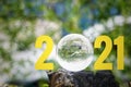 2021 text with lens ball and blur nature background. The beginning of the new year. Royalty Free Stock Photo