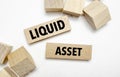 Text LIQUID ASSET on wooden blocks. concept business succeed Royalty Free Stock Photo
