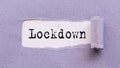 The text LOCKDOWN appears on torn lilac paper against a white background