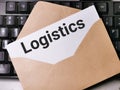 Text LOGISTICS written on white paper note in the envelope on computer keyboard. Royalty Free Stock Photo