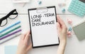 Text LONG-TERM CARE INSURANCE on clipboard