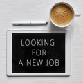 Text looking for a new job in a tablet Royalty Free Stock Photo