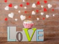 Text love and cupcake with heart shapes