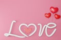 Text LOVE  Realistic 3D Colorful Romantic Valentine Hearts in Red or Pink Background. 3D render Royalty Free Stock Photo