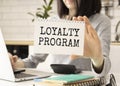 Text on Loyalty Program card in hand young Royalty Free Stock Photo