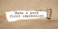 The text Make a good first impression appearing behind torn brown paper Royalty Free Stock Photo