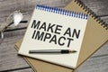Text MAKE AN IMPACT on the white paper and glasses Royalty Free Stock Photo