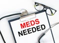 Text Meds Needed in the folder with the stethoscope and glasses