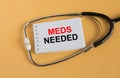 Text Meds Needed on a notepad with a stethoscope lying on a orange background