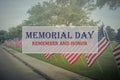 Text Memorial Day and Honor on row of lawn American Flags Royalty Free Stock Photo