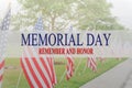 Text Memorial Day and honor on row of lawn American Flags Royalty Free Stock Photo