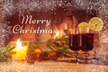 Text Merry Christmas on the background of a beautiful image with mulled wine and a fireplace. Romantic Christmas Card