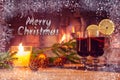 Text Merry Christmas on the background of a beautiful image with mulled wine and a fireplace. Romantic Christmas Card Royalty Free Stock Photo