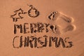 Text merry christmas in the sand of a beach Royalty Free Stock Photo