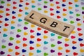 Text message LGBT for protest action. Selective focus on Lettering LGBT with copy space. Banner on colorful background with hearts Royalty Free Stock Photo