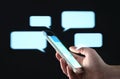 Text messages in cellphone screen with abstract hologram speech bubbles. Instant messaging app. Texting, group chat, sexting.